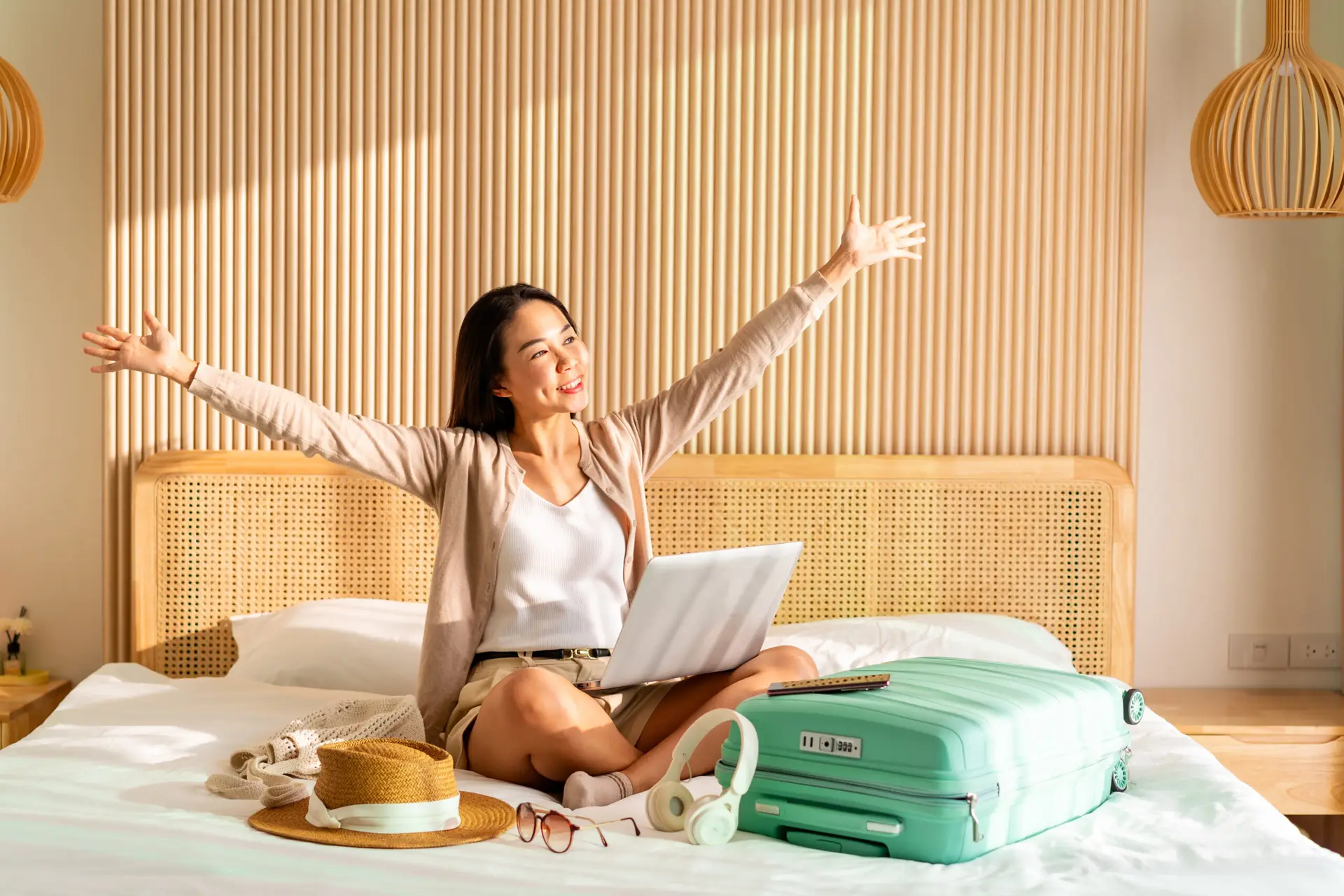 girl with suitcase on hotel bed