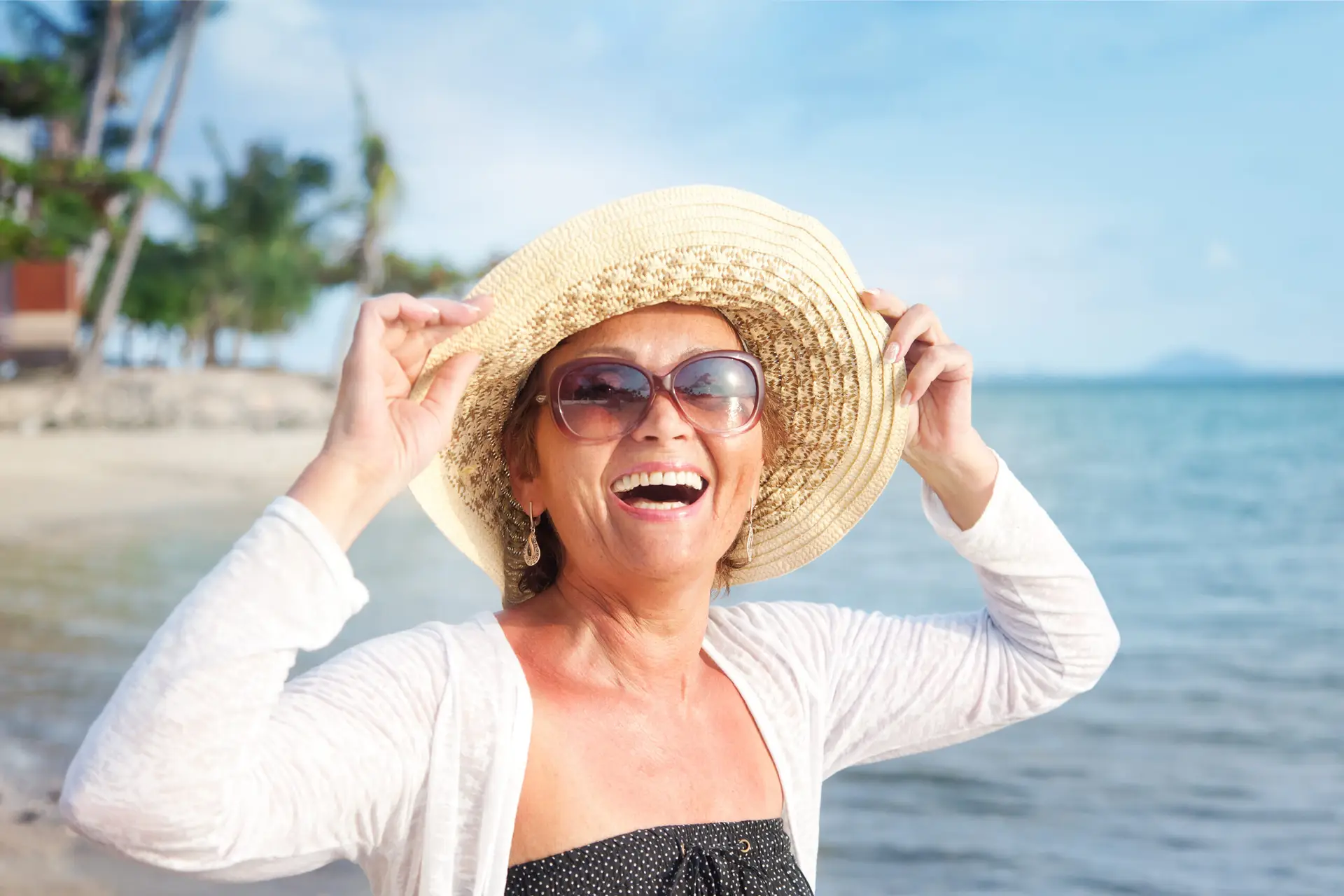 Happy nature woman of 50 years on the beach