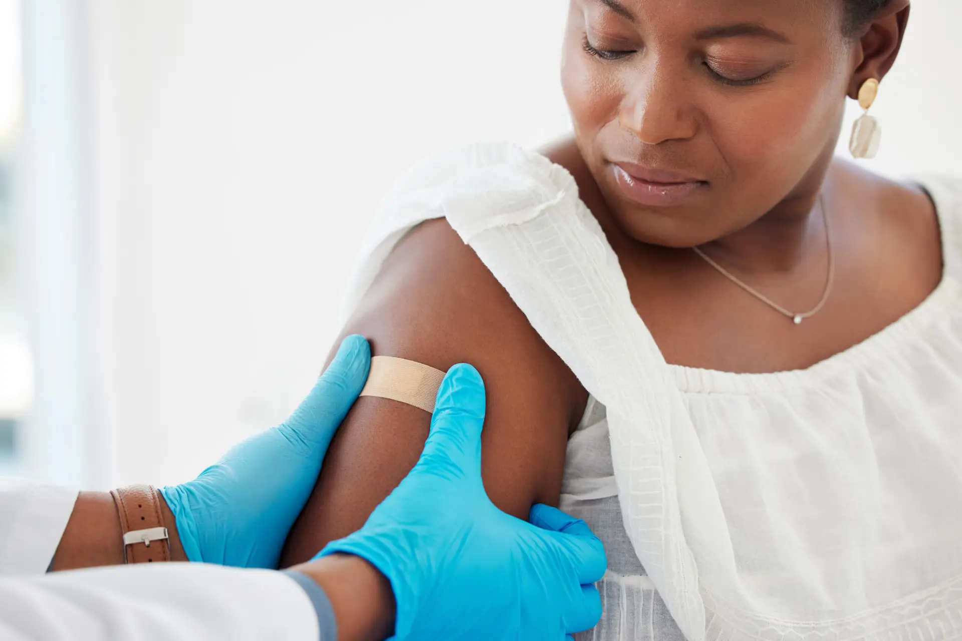 woman with bandaid after getting a shot