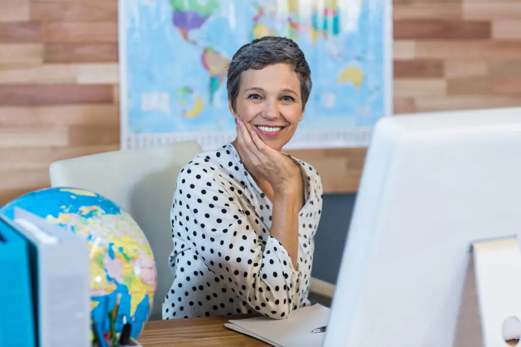 Smiling businesswoman sitting at her desk
