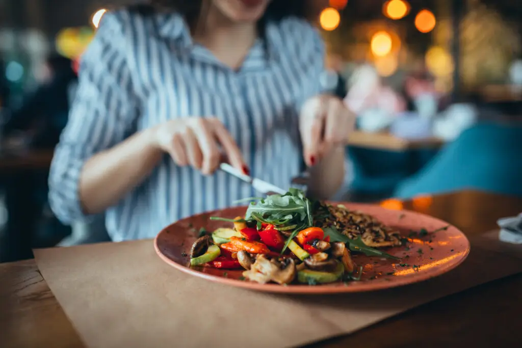 close up of woman in restaurant eating