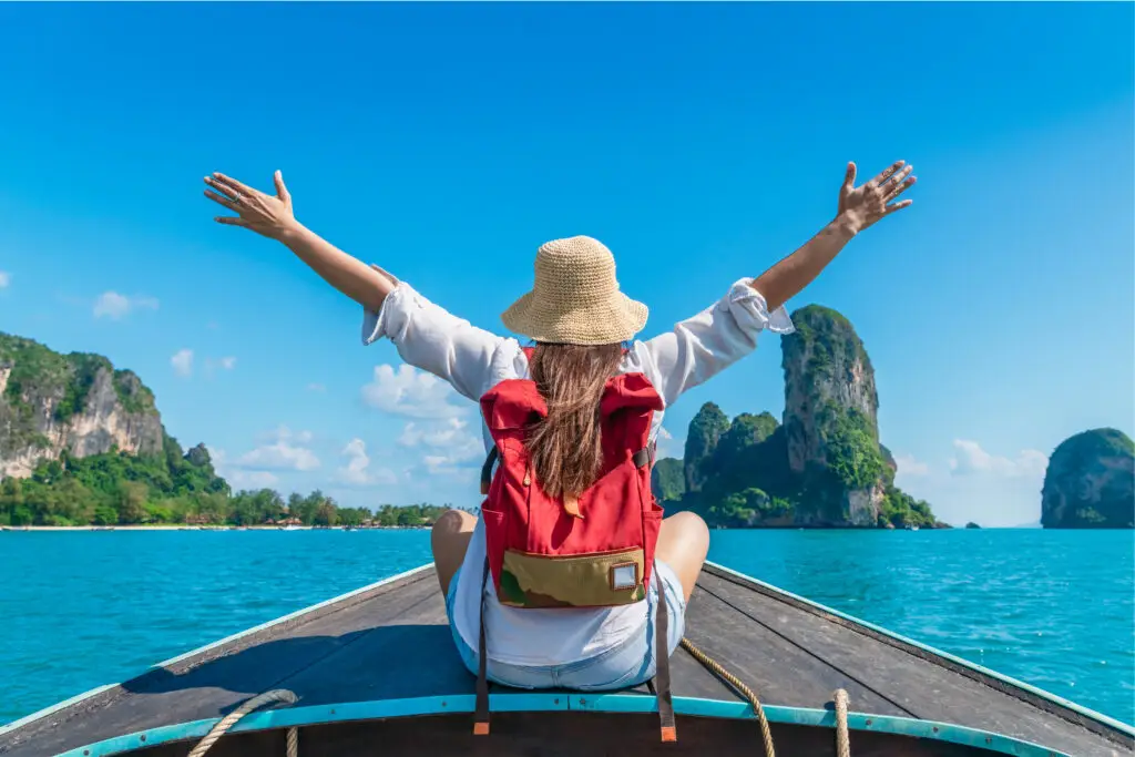 Happy traveler woman on boat joy fun nature view