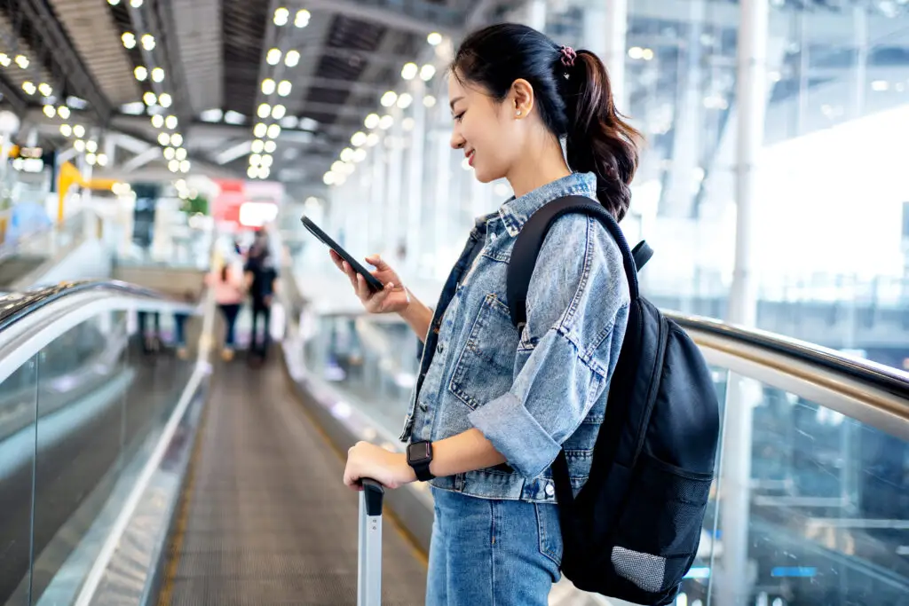 Woman using phone at airport