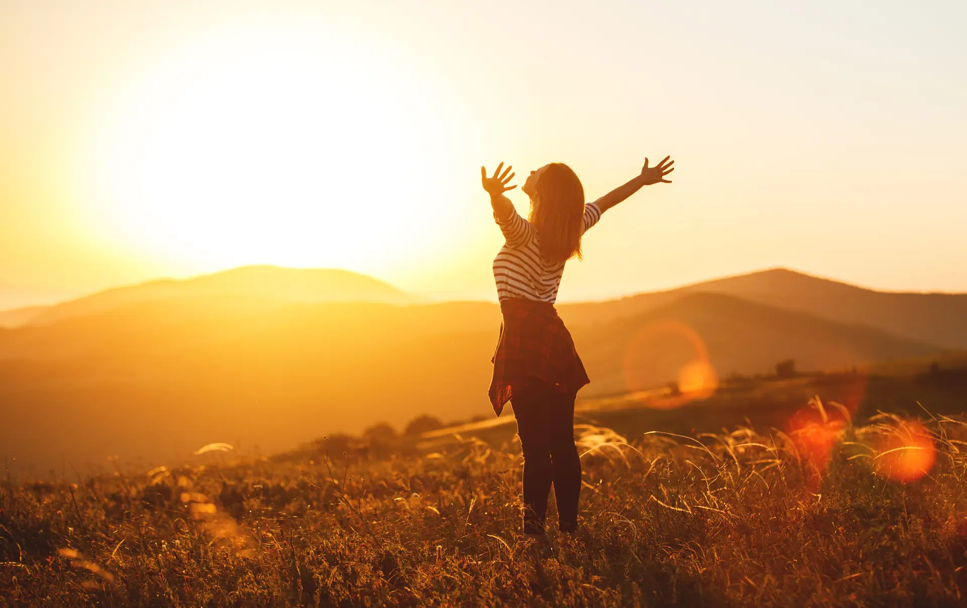 women taking a big breath in the beauty of nature while traveling solo