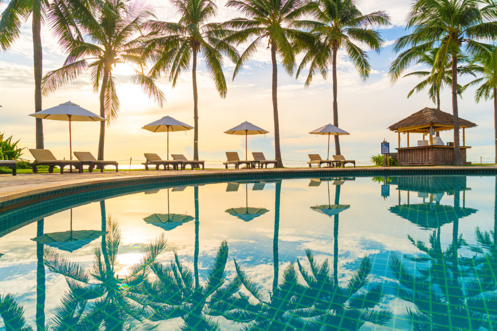Beautiful luxury umbrella and chair around outdoor swimming pool