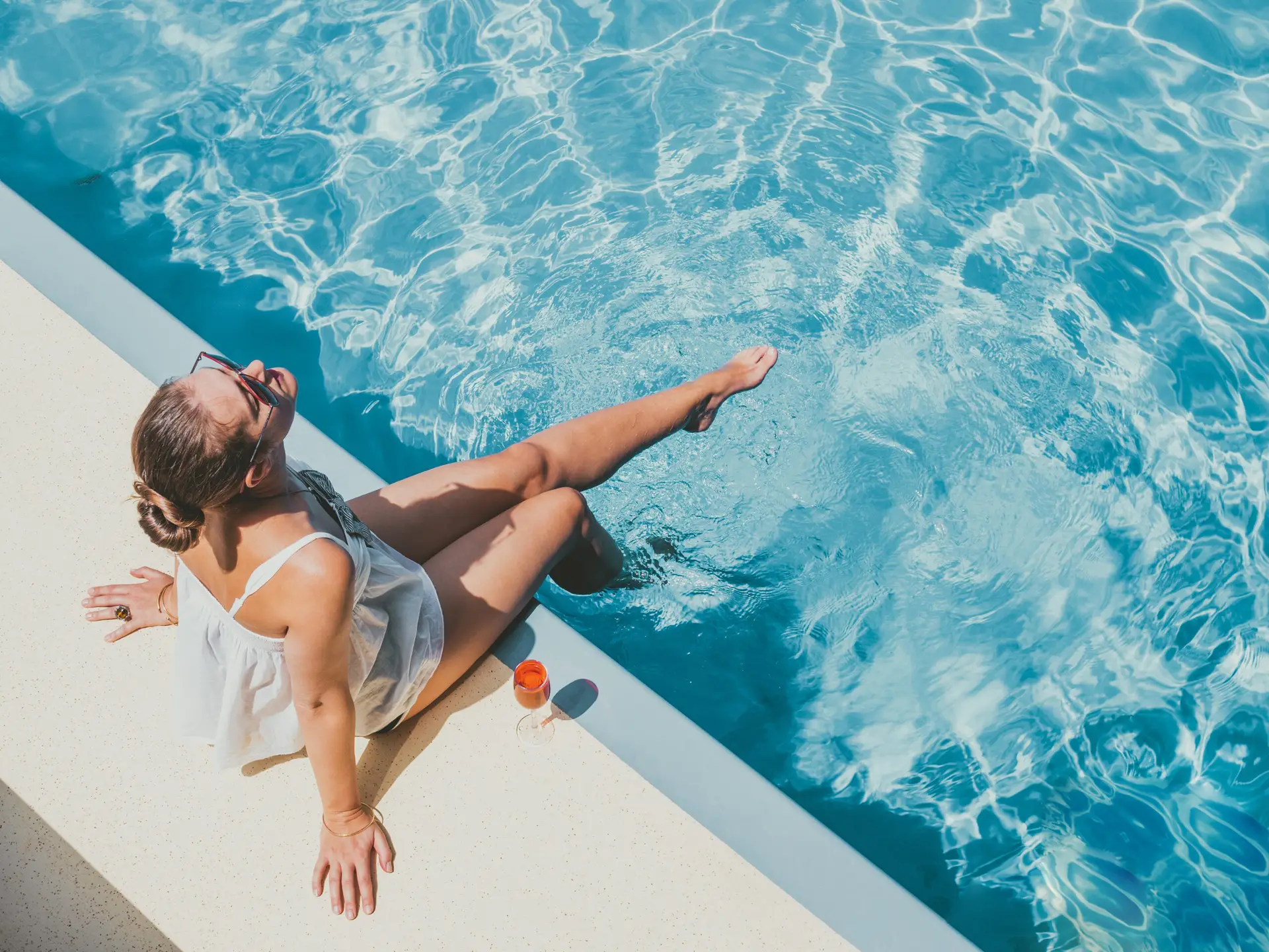 women relaxing by the pool on her vacation