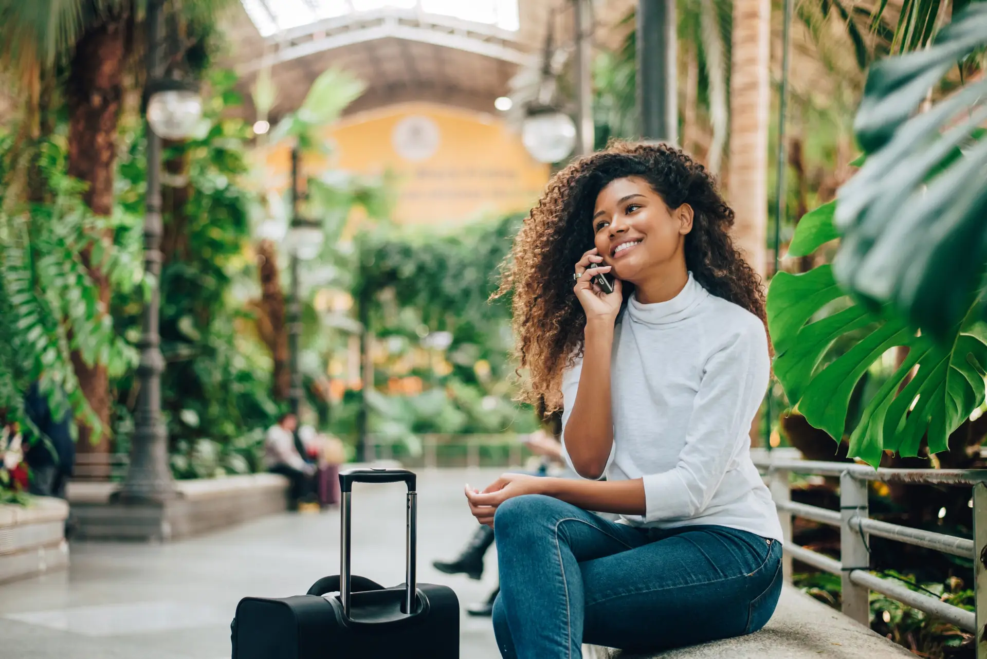 women on her cell phone while traveling
