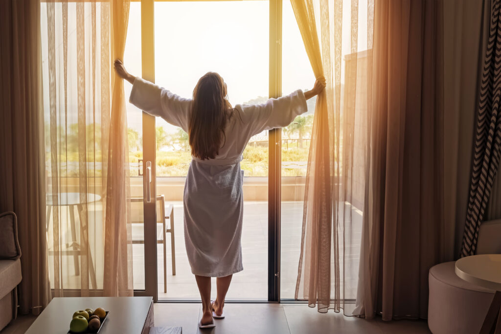 women feeling refreshed in her hotel room