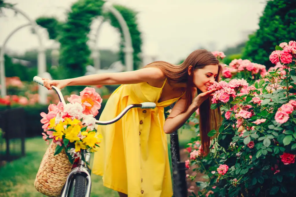 woman smelling the flowers on a solo trip